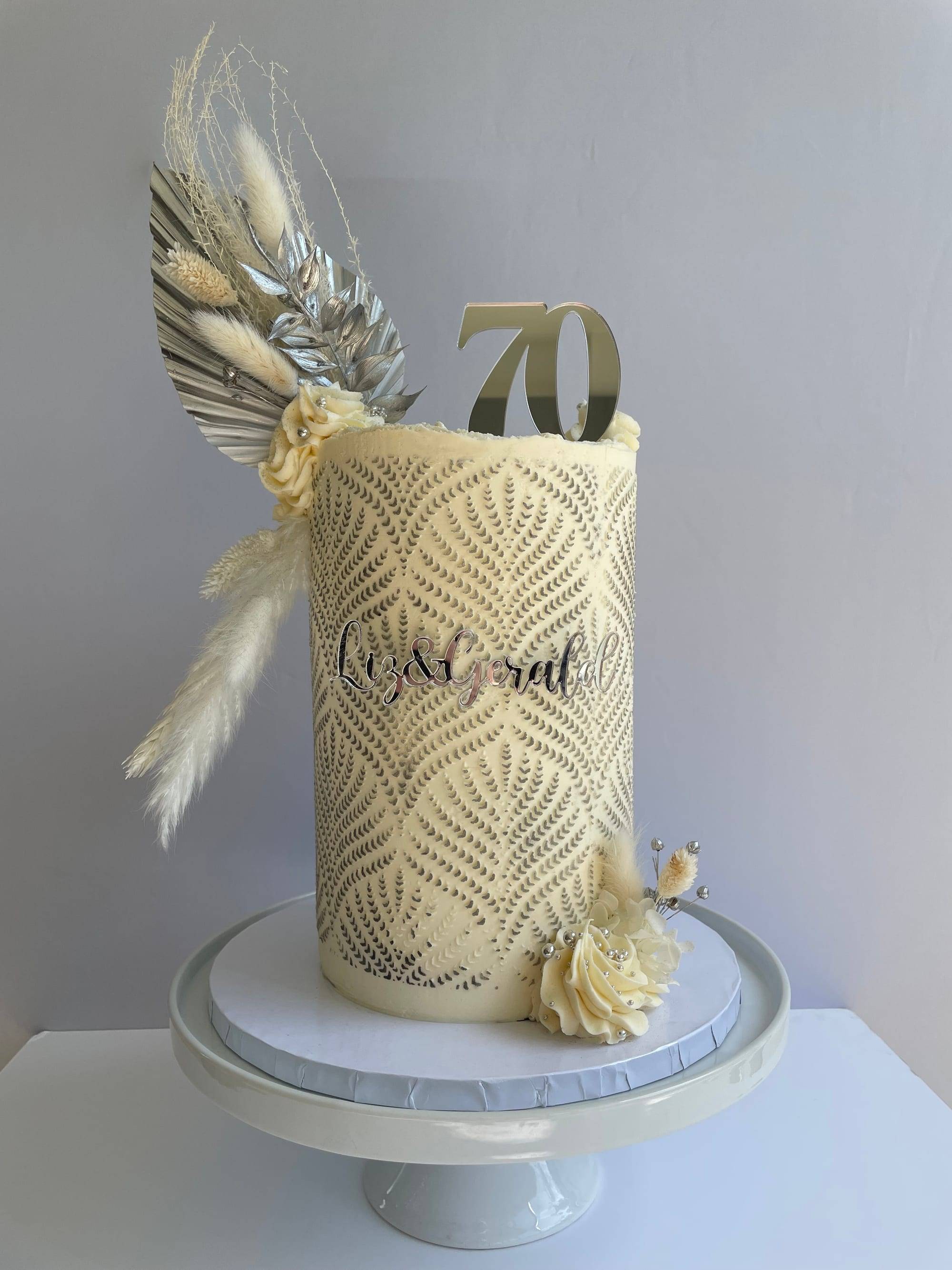 70th anniversary cake with ivory buttercream stencilled in a silver fern pattern