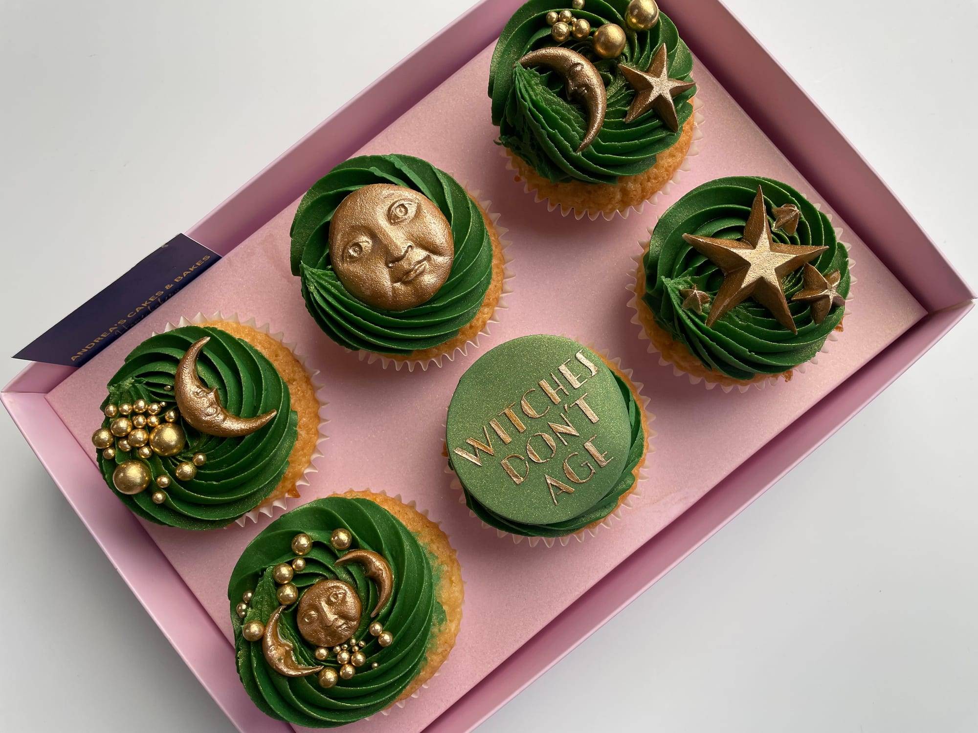 Halloween cupcakes with dark green buttercream and gold moon, star and Witches Don't Age toppers